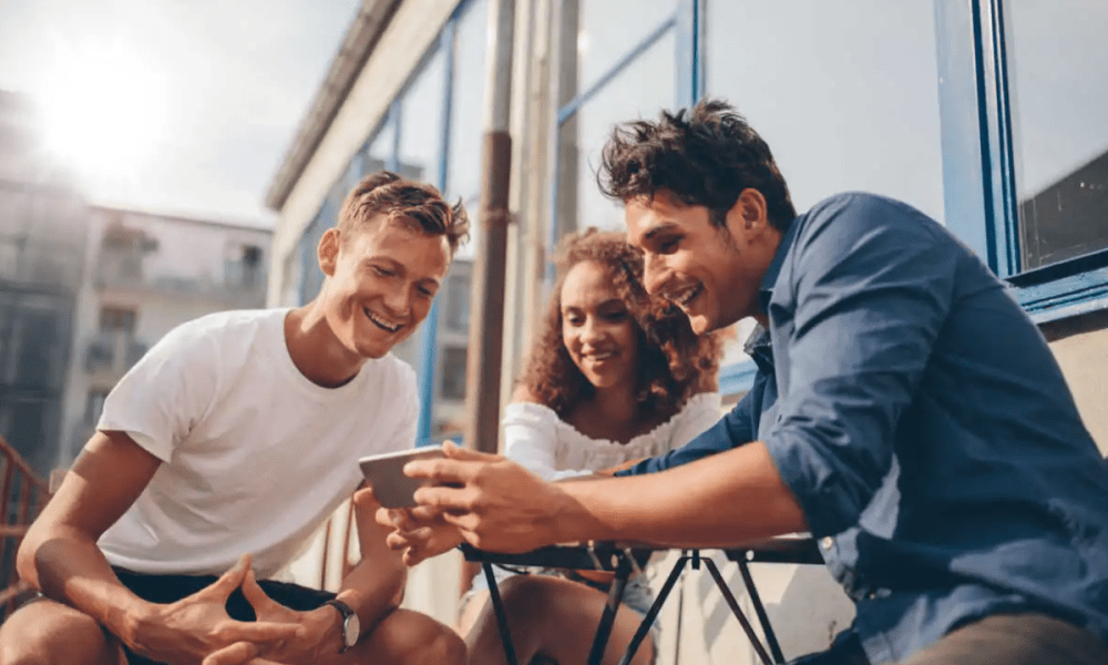 three people viewing mobile app