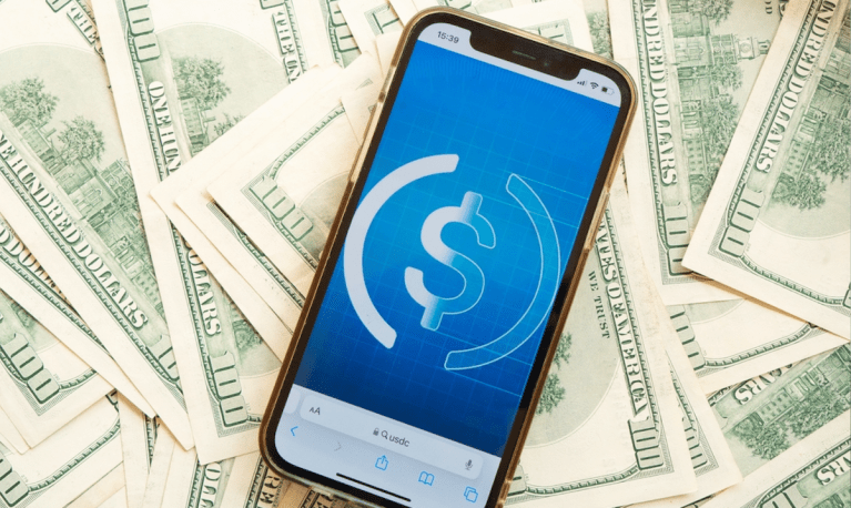 cash and phone with stablecoin symbol